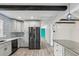 Modern kitchen with gray cabinets, stainless steel appliances, and breakfast bar at 126 90Th Ave, Treasure Island, FL 33706