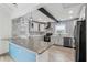 Modern kitchen with gray cabinets, blue tile backsplash, and stainless steel appliances at 126 90Th Ave, Treasure Island, FL 33706