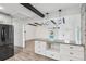 Modern kitchen with gray cabinets, breakfast bar, and view into living area at 126 90Th Ave, Treasure Island, FL 33706