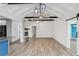 Open living area with high ceiling, hardwood floors, and fireplace at 126 90Th Ave, Treasure Island, FL 33706