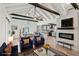 Open living area with vaulted ceilings, exposed beams, and a modern fireplace at 126 90Th Ave, Treasure Island, FL 33706