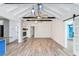 Bright living room with vaulted ceiling, hardwood floors, and barn door at 126 90Th Ave, Treasure Island, FL 33706