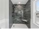 Large walk-in shower with gray tile and built-in seat at 126 90Th Ave, Treasure Island, FL 33706