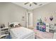 Light and airy bedroom with a twin bed and playful decor at 13038 Paddock Woods Pl, Riverview, FL 33579