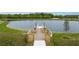 Fishing pier extending over a tranquil lake at 13038 Paddock Woods Pl, Riverview, FL 33579