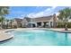 Community pool with a water feature and lounge chairs at 13038 Paddock Woods Pl, Riverview, FL 33579