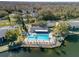 Resort-style pool and sundeck overlooking a lake at 1488 Pine Glen Ln # B2, Tarpon Springs, FL 34688