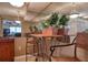 Small breakfast nook with wicker chairs and a wooden table at 1488 Pine Glen Ln # B2, Tarpon Springs, FL 34688