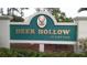 Entrance sign for Deer Hollow at East Lake community at 1488 Pine Glen Ln # B2, Tarpon Springs, FL 34688