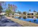 Paved walkway winds beside a tranquil lake in a Florida community at 1488 Pine Glen Ln # B2, Tarpon Springs, FL 34688