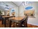 Bright dining area with wood table and chairs, reflecting mirror and kitchen pass-through at 1488 Pine Glen Ln # B2, Tarpon Springs, FL 34688