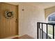 Inviting condo entry with wreath and view to a pond at 1488 Pine Glen Ln # B2, Tarpon Springs, FL 34688