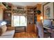 Bright home office features built-in shelves and a comfortable sitting area at 1488 Pine Glen Ln # B2, Tarpon Springs, FL 34688