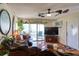 Spacious living area with hardwood floors, comfy seating and a large TV at 1488 Pine Glen Ln # B2, Tarpon Springs, FL 34688