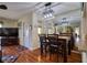 Living room with wood floors, TV, and access to the front door and kitchen at 1488 Pine Glen Ln # B2, Tarpon Springs, FL 34688