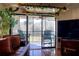 Living room with access to a screened balcony and lake view at 1488 Pine Glen Ln # B2, Tarpon Springs, FL 34688