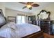 Main bedroom with king-size bed, dresser, and large TV at 1488 Pine Glen Ln # B2, Tarpon Springs, FL 34688