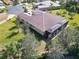 Aerial view of a home with a large backyard and screened patio at 15618 Aurora Lake Cir, Wimauma, FL 33598