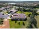 Aerial view highlighting a home's backyard and screened enclosure at 15618 Aurora Lake Cir, Wimauma, FL 33598