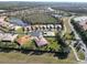 Aerial view of a luxury home community with lakes and lush landscaping at 15618 Aurora Lake Cir, Wimauma, FL 33598