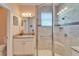 Bathroom with shower, granite vanity, and window at 15618 Aurora Lake Cir, Wimauma, FL 33598