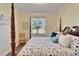 Bedroom with a four-poster bed, window, and neutral decor at 15618 Aurora Lake Cir, Wimauma, FL 33598