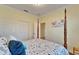 Bedroom with four poster bed, and sliding door to closet at 15618 Aurora Lake Cir, Wimauma, FL 33598