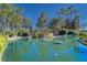 Valencia Lakes community entrance with a pond and landscaping at 15618 Aurora Lake Cir, Wimauma, FL 33598