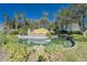 Valencia Lakes community entrance with a pond and lush landscaping at 15618 Aurora Lake Cir, Wimauma, FL 33598