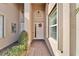 Front entry with a light-colored door and neutral-toned tile flooring at 15618 Aurora Lake Cir, Wimauma, FL 33598