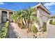 Brick walkway leads to the front door of this charming house with palm trees at 15618 Aurora Lake Cir, Wimauma, FL 33598