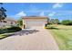 House exterior showcasing a welcoming front entrance and a brick driveway at 15618 Aurora Lake Cir, Wimauma, FL 33598