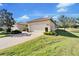 Front view of a lovely house with a two-car garage and manicured lawn at 15618 Aurora Lake Cir, Wimauma, FL 33598