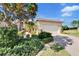 Well-maintained house with a paved driveway and lush landscaping at 15618 Aurora Lake Cir, Wimauma, FL 33598