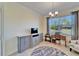 Bright home office with built-in cabinetry, desk, and window at 15618 Aurora Lake Cir, Wimauma, FL 33598
