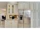 Kitchen features granite countertops, white cabinets, and built-in coffee station at 15618 Aurora Lake Cir, Wimauma, FL 33598