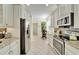 Modern kitchen with stainless steel appliances and granite countertops at 15618 Aurora Lake Cir, Wimauma, FL 33598