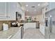 Modern kitchen with stainless steel appliances and granite countertops at 15618 Aurora Lake Cir, Wimauma, FL 33598