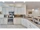 Modern kitchen with stainless steel appliances and granite countertops at 15618 Aurora Lake Cir, Wimauma, FL 33598