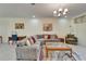 Comfortable living room with sectional sofa, large windows and tiled floors at 15618 Aurora Lake Cir, Wimauma, FL 33598