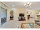 Open living space with a view into the main bedroom and access to patio at 15618 Aurora Lake Cir, Wimauma, FL 33598