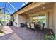 Relaxing patio area with seating, a table, and access to the interior at 15618 Aurora Lake Cir, Wimauma, FL 33598