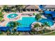 Community pool with lounge chairs and landscaping at 15618 Aurora Lake Cir, Wimauma, FL 33598