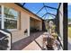 Outdoor space featuring a screened patio, brick pavers, and grill at 15618 Aurora Lake Cir, Wimauma, FL 33598