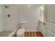 Clean bathroom with a shower, toilet, and vanity with quartz top at 1566 Long St, Clearwater, FL 33755