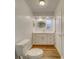 Bright bathroom with white cabinets and quartz countertop at 1566 Long St, Clearwater, FL 33755