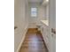 Clean bathroom with white cabinets and wood-look floors at 1566 Long St, Clearwater, FL 33755