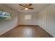 Well-lit bedroom with wood-look floors and ceiling fan at 1566 Long St, Clearwater, FL 33755