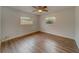 Spacious bedroom with wood-look floors and two windows at 1566 Long St, Clearwater, FL 33755