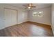 Bedroom with wood-look floors, ceiling fan and double closets at 1566 Long St, Clearwater, FL 33755